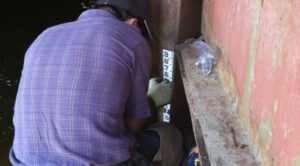 Brian Epstein, Hydrologist-Hydrographer at the CWCB, installs a staff gage to measure flows