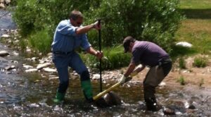 Kirk Klancke and Brian Epstein - clearing a cross section of river to measure flows accurately